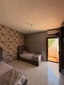a bedroom with two beds and a window at Boustan homes in Cabo Negro