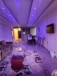 a living room with a couch and a table at Abu safa home in Al Ghuşnah