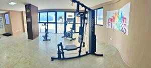 a gym with several tread machines in a room at Vacanze - Neo in Maceió