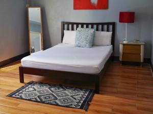 a bedroom with a bed with a mirror and a rug at Apartment with Kitchen Walking Distance to Station Two in Boracay