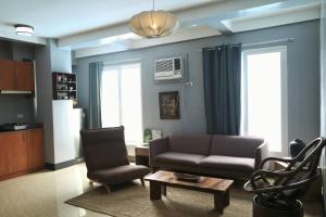 a living room with a couch and chairs and a table at Apartment with Kitchen Walking Distance to Station Two in Boracay