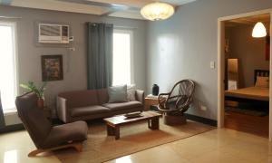 a living room with a couch and a chair at Apartment with Kitchen Walking Distance to Station Two in Boracay