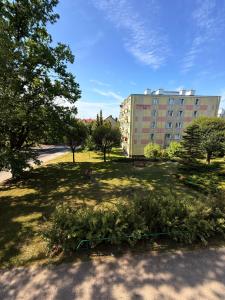 a park with trees and a building in the background at Robotnicza 59 Old Town Apartment in Elblag +53 photos