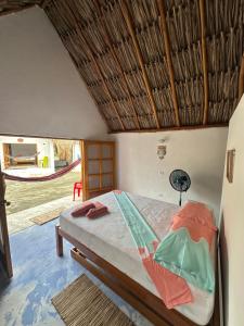 a bedroom with a bed with a hammock in it at Karpatty Mar Cabañas in San Bernardo del Viento