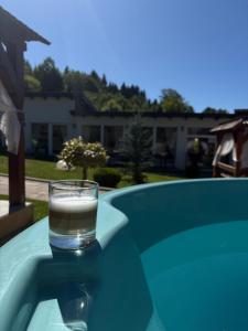 a glass of water sitting on top of a table at Casa Ina in Moisei