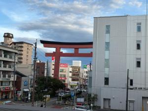 a large red torii gate on the side of a building at Stay min NAKAMURA in Nagoya