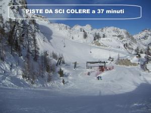 a group of people on a ski lift in the snow at Casa Vacanze da Emanuela in Darfo