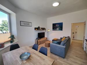 a living room with a couch and a table at Apartment Sarah LIL SIS in Tulln