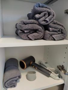 a pile of towels sitting on a shelf at Apartment Sarah LIL SIS in Tulln