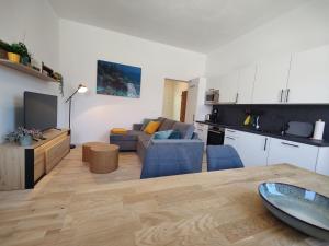 a kitchen and a living room with a couch and a table at Apartment Sarah LIL SIS in Tulln