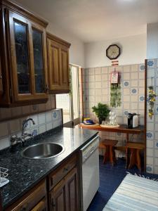 a kitchen with a sink and a counter at Geninha Stay Aveiro in Aveiro +18 photos