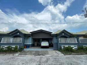 a house with a car parked in front of it at Brian Castle in Tagum