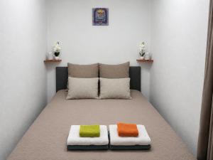 a room with a bed with two pillows on it at Gunilak in Dombóvár