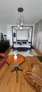 a living room with a coffee table and a chandelier at Chez Mary in Larzicourt