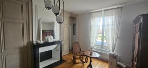 a living room with a fireplace and a mirror at Chez Mary in Larzicourt