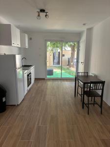 a living room with a table and a kitchen at NovaStay in Breuillet