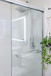 a shower with a glass door and a window at The Mira Mesa Gamezone in San Diego +52 photos