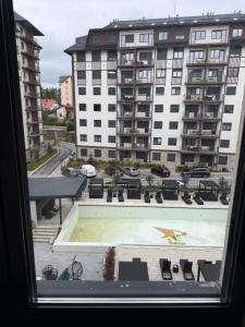 a view from a window of a building with a pool at Amara in Zlatibor