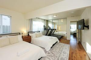 a bedroom with two beds and a large mirror at The Mira Mesa Gamezone in San Diego