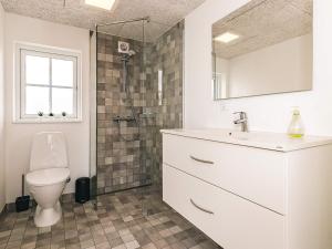 a bathroom with a toilet and a sink and a shower at 8 person holiday home in Læsø in Læsø +40 photos