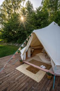 a large white tent on a wooden deck at Glamping Ty Západy in Stanový