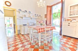 a kitchen with a table and chairs in a room at Villa Bellavista - Tuscany panoramic view in Crespina