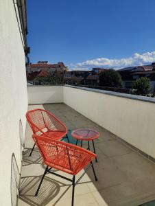 two chairs and a table on a balcony at Apartment Felicitas FEE in Tulln