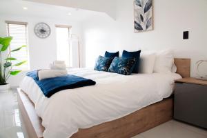 a bedroom with a large white bed with blue pillows at Ipanima palace in New Germany