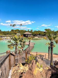 a view of a beach with palm trees and a boardwalk at Alisios Kite Lodge in Cumbuco