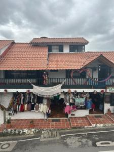 a building with a store with clothes in front of it at Hotel Lancers in Paipa
