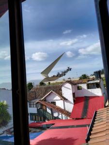 a view from a window of buildings and an airplane at Hotel Lancers in Paipa