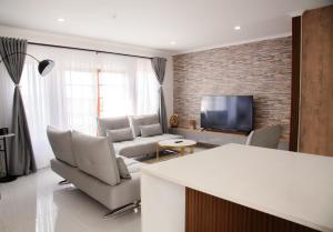 a living room with white furniture and a tv at Ipanima palace in New Germany