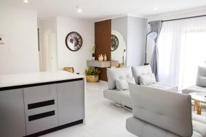 a white living room with a couch and a table at Ipanima palace in New Germany +15 photos