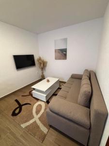 a living room with a couch and a table at Aurea Novi 3 in Herceg-Novi