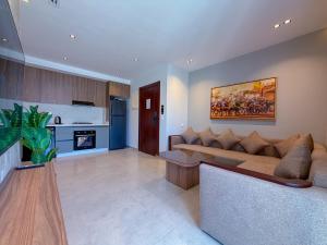 a living room with a couch and a fireplace at Résidence Oscar - Pool & View in M'diq