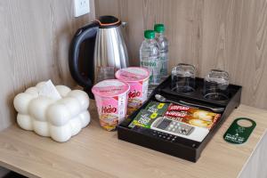 a counter with a coffee maker and food on it at LUNA Hotel in Vĩnh Long