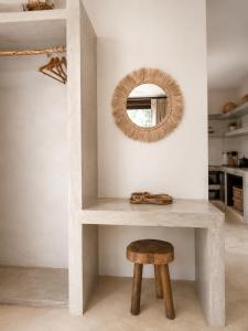 a console table with a stool and a mirror at Ikal Bungalows Tulum in Tulum +56 photos