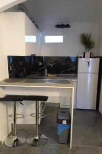 a kitchen with a sink and a refrigerator at Apartments by the sea Postira, Brac - 9241 in Postira +15 photos