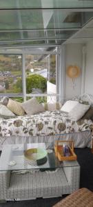 a living room with a bed and a glass table at Hillview Homestay in Richmond