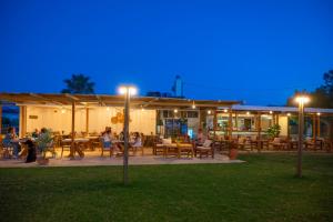 people sitting at tables outside of a restaurant at night at Naya in Kissamos