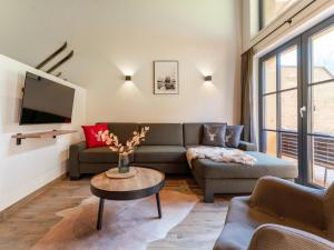 a living room with a couch and a table at Almrausch in Wald im Pinzgau
