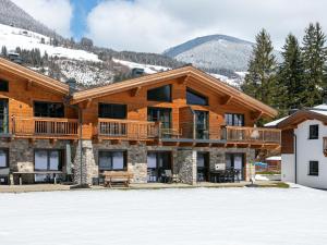 a log cabin with snow in front of it at Almrausch in Wald im Pinzgau