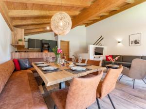 a dining room with a table and a couch at Almrausch in Wald im Pinzgau
