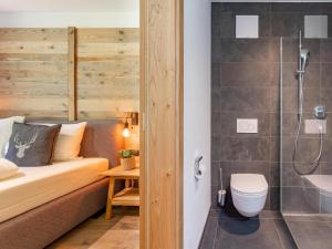 a bathroom with a bed and a shower and a toilet at Almrausch in Wald im Pinzgau +39 photos