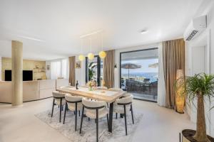 a kitchen and dining room with a table and chairs at View Villas Collection in Vinišće