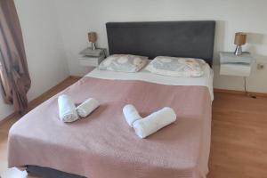 a bedroom with a bed with two towels on it at Apartment Ugljan 846b in Ugljan