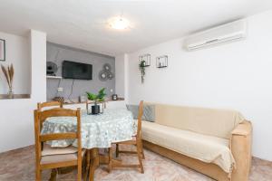 a living room with a table and a couch at Apartments with parking space Sutivan, Brac - 2846 in Sutivan