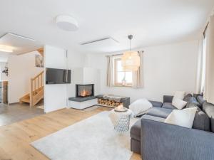 a living room with a couch and a fireplace at Bergzauber in Donnersbachwald