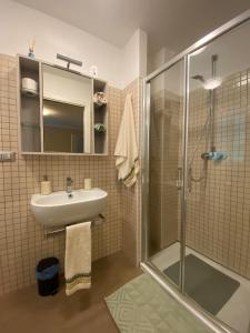 a bathroom with a sink and a shower at AFFITTACAMERE PIAZZA UNITA' in Monfalcone