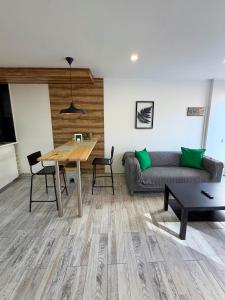 a living room with a table and a couch at Cactus Apartment in Playa Fañabe